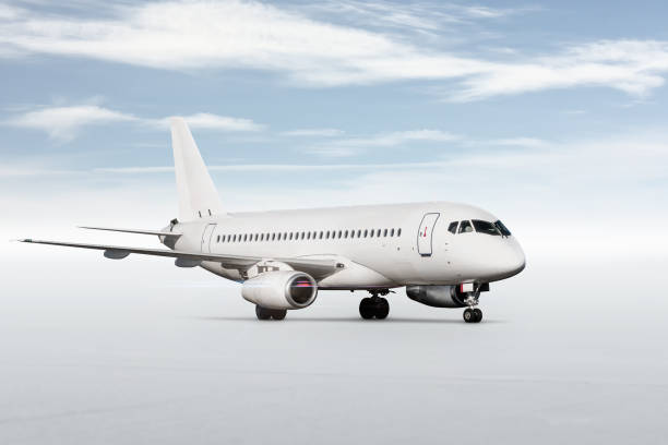 istock White passenger aircraft isolated on bright background with sky 1471243270