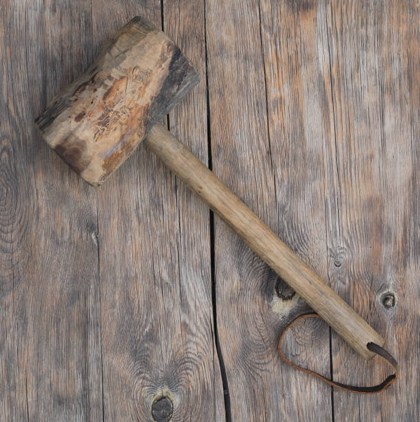 istock ancient wooden hammer on wooden background 1471244250