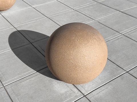 Large concrete sphere on a sidewalk