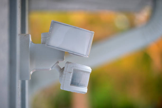 istock Motion sensor with light detector mounted on exterior wall of private house as part of security system 1471244728