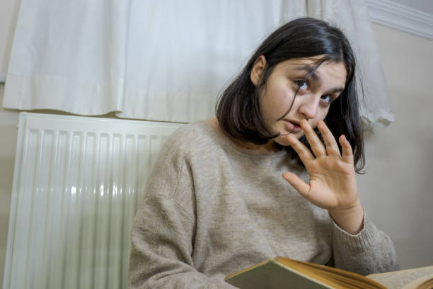 istock young teenager warning to stop because she is reading a book 1471246368