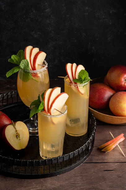 istock Three glasses of refreshing apple cocktail drinks with fresh red apples, dark background 1471252458