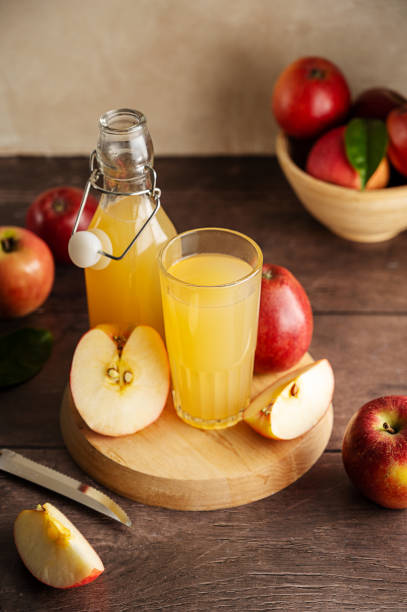 istock Apple juice drink with fresh red apples, wooden background. Copy space. 1471252540