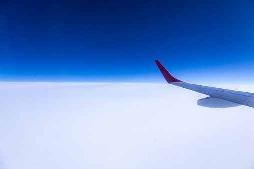 View of the wing of an airplane during a flight in the sky.
