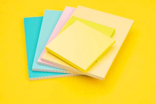 istock A stack of papers for notes and stickers on a yellow background as a concept of work in the office 1471253139