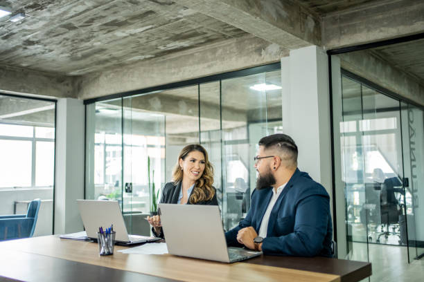 istock Coworkers talking in the office 1471254519