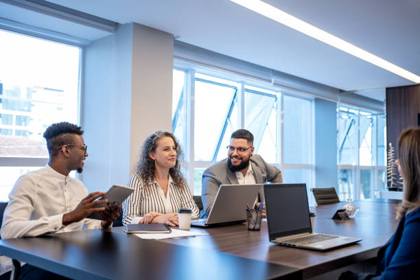 istock Coworkers talking in the office 1471254635