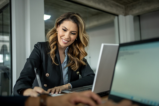 Businesswoman signing document in modern office