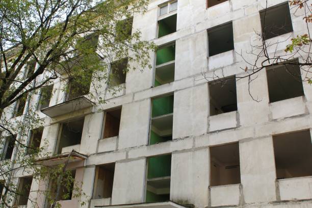 istock Old evicted and destroyed panel house for demolition with broken windows after resettlement. Relocation and refugee concept 1471256226