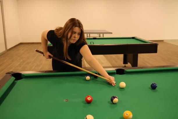 istock Girl is playing billiards 1471258152