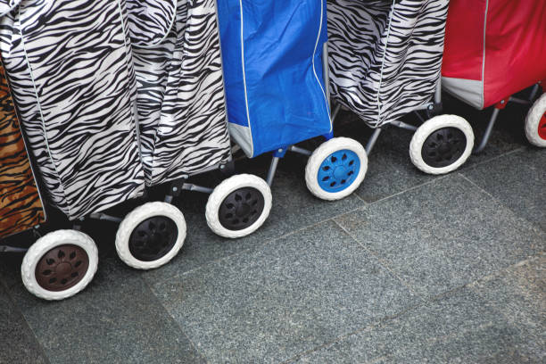 American young housewife shopping for a new baby stroller in a baby store