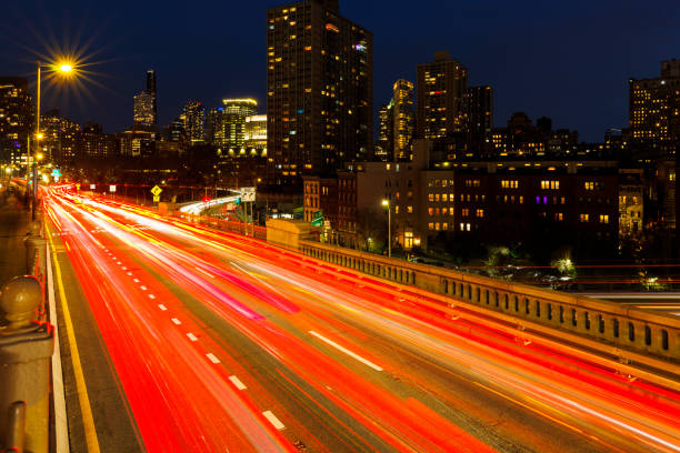 Brooklyn Bridge, illuminated at night, with the view of Brooklyn modern buildings.