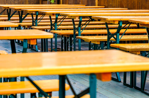 istock typical bavarian beergarden with wooden benches and tables 1471263252