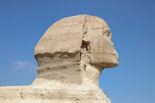 The Majestic Sphinx of Giza. \n\nThe largest and most famous sphinx is the Great Sphinx of Giza, situated on the Giza Plateau adjacent to the Great Pyramids of Giza on the west bank of the Nile River and facing east (29°58′31″N 31°08′15″E). The sphinx is located southeast of the pyramids. While the date of its construction is not known for certain, the general consensus among Egyptologists is that the head of the Great Sphinx bears the likeness of the pharaoh Khafre, dating it to between 2600 and 2500 BC.
