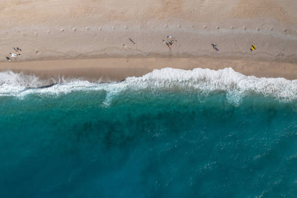 istock deserted sandy beach and turquoise sea waves 1471266873