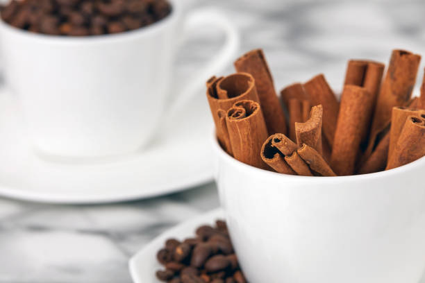 sticks of fragrant cinnamon in a white mug close-up