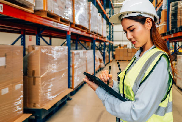 istock Warehouse manager in white helmet using tablet for checking goods on shelves 1471275509
