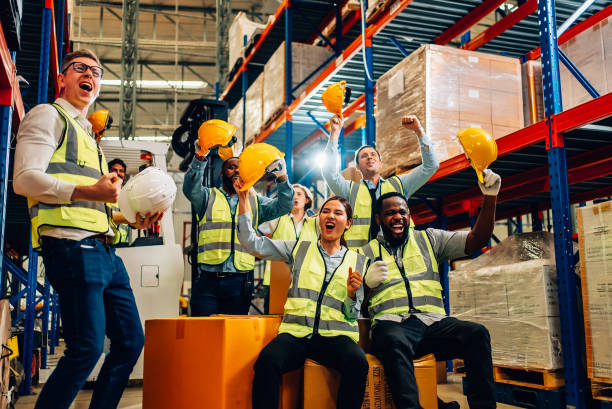 istock Professional warehouse worker team celebrating success in warehouse factory 1471276298