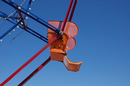 Colorful Ferris wheel against a bright blue sky