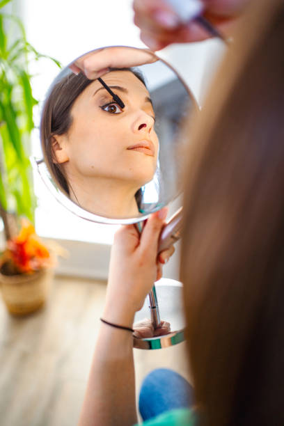 istock Beautiful woman applying mascara on her eyelashes 1471277975