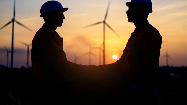 istock Professional engineer technician working outdoor at wind turbine field 1471281464