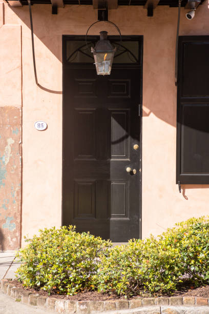 Close-up of door and gas lamp  in full morning sun, French Quarter, Charleston, South Carolina stock photo