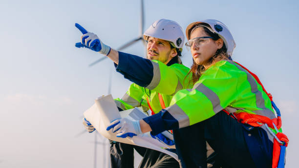 istock Professional engineer technician working outdoor at wind turbine field 1471282738