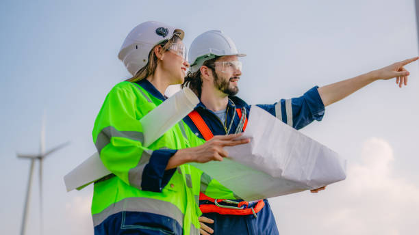 istock Professional engineer technician working outdoor at wind turbine field 1471284303