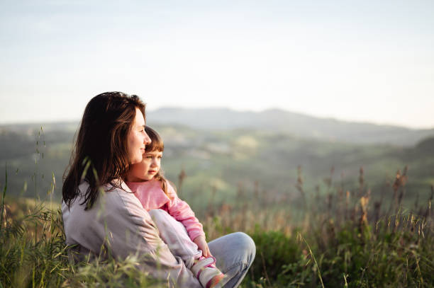 istock mote embracing her daughter in a sunset meadow. 1471291555