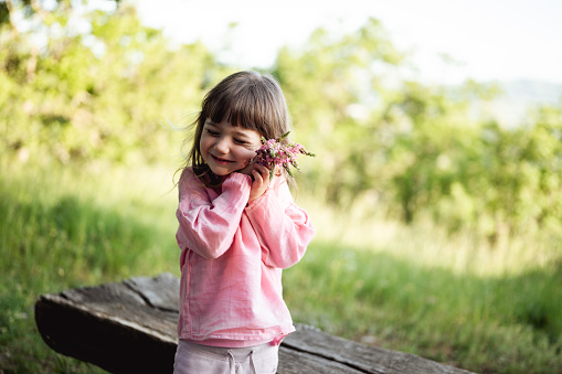 affectionate little girl holding flowers.