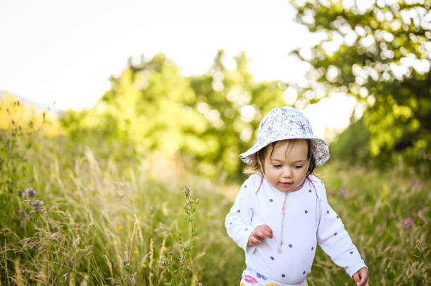 istock little child walking in a sunny field. 1471294109