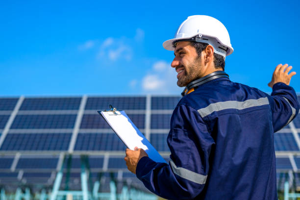 istock Engineer worker portrait with solar panel at solar farm 1471297037