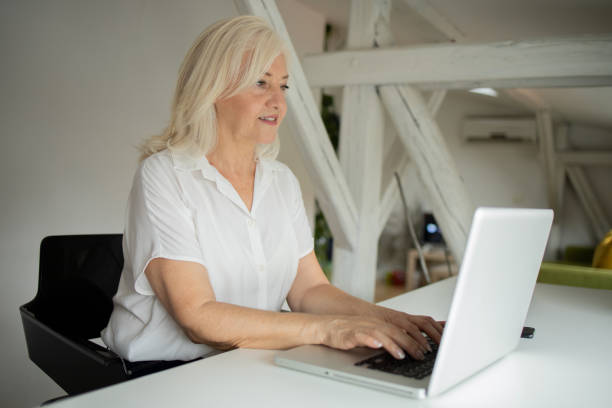 istock Senior woman working from home 1471298234