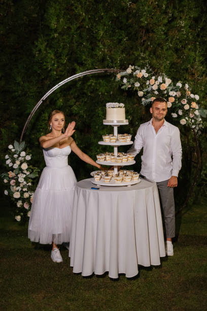 istock newlyweds happily cut and taste the wedding cake 1471298435