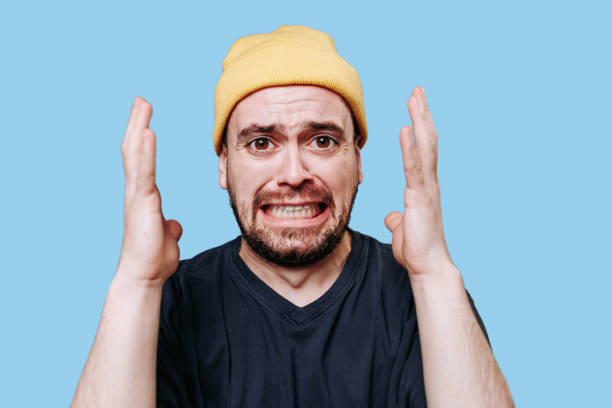 istock A violent male is captured in this close-up studio shot, his expression filled with anger 1471298627