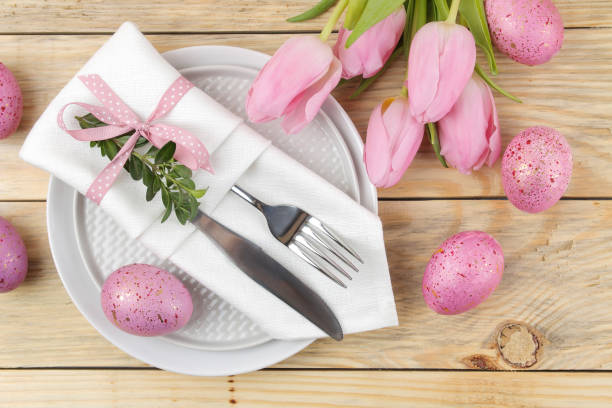 istock Easter. Easter table setting. Pink Easter eggs and flowers tulips on a natural wooden table. Happy easter. holidays. top view 1471298872