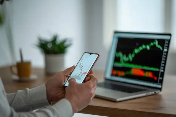 Photo of Day trading stocks. Trader studying stock markets on TradingView app.