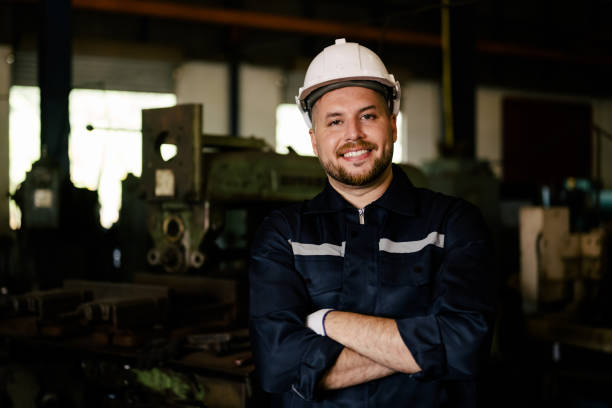 istock Portrait of engineer worker with white helmet smiling to camera 1471304152