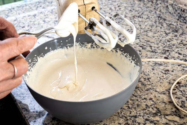 istock Woman cook putting ingredient into cheesecake preparation container. 1471304988