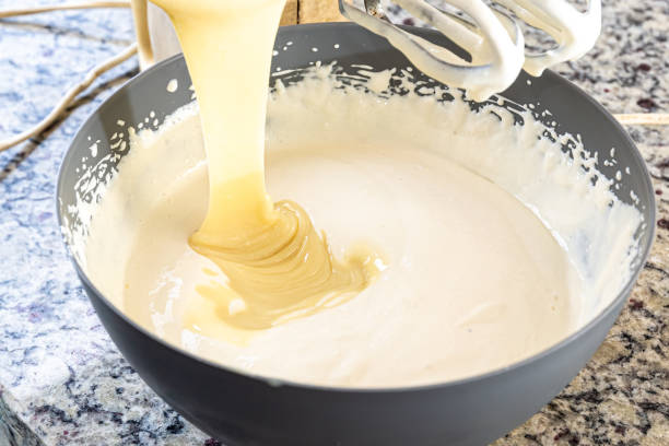 istock Creamy ingredient being poured into the cheesecake pan. 1471304991