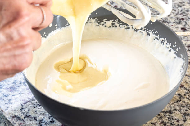 istock Creamy ingredient being poured into the cheesecake pan. 1471304993