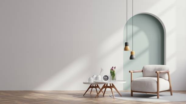 空の白い壁の背景にスカンジナビアのリビングルームとグレイの肘掛け椅子。 - contemporary indoors sparse living room ストックフォトと画像