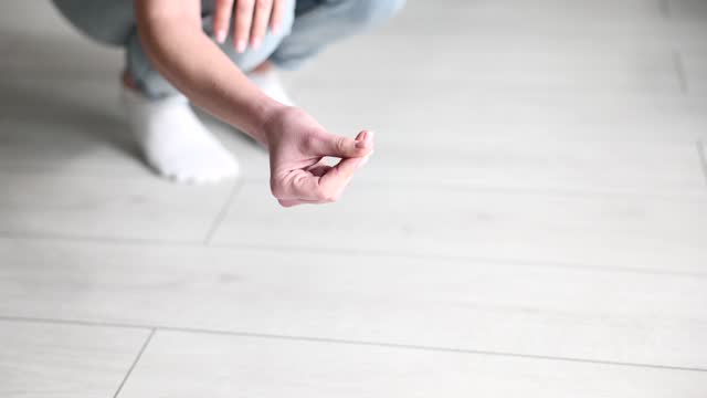 Housewife woman points finger at dirt on floor