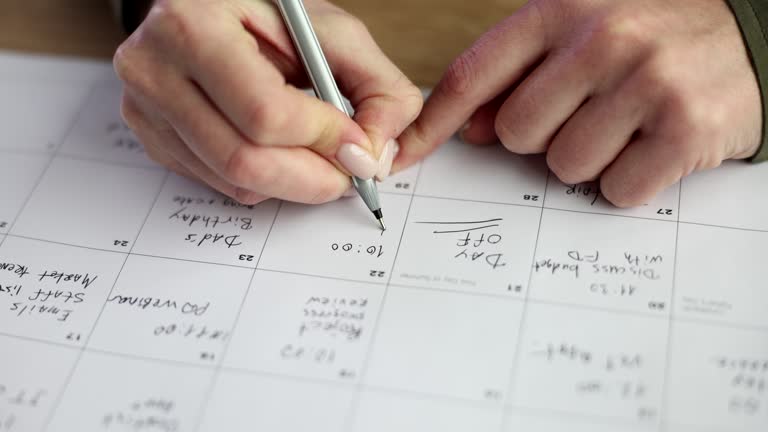 Manager and seo writes calendar for planning affairs and meetings