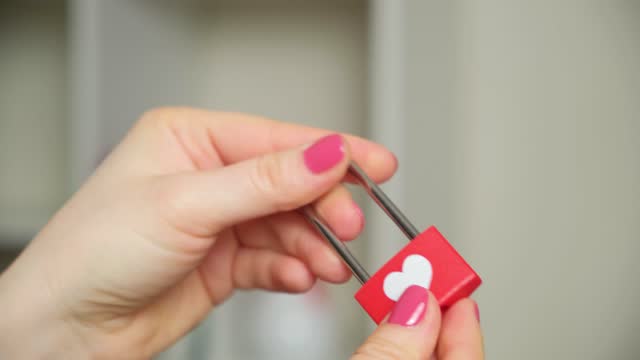 Valentine's Day Concept, Lock for Lovers with Heart in Women's Hands, Open Key