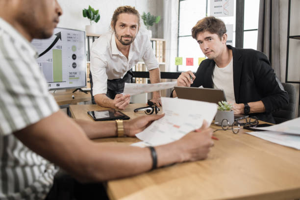 istock Men colleagues discussing common business project. 1471312960