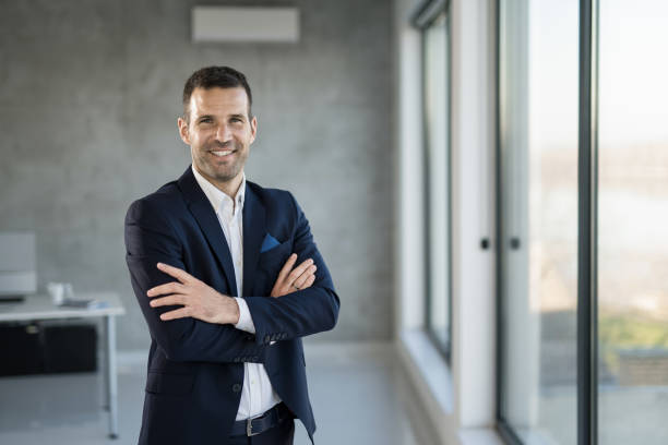 istock Happy businessman looking at camera in the office. 1471317872