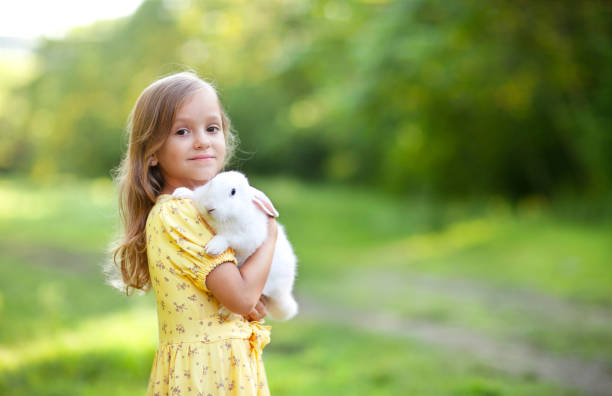 istock a little girl with white rabbit on 1471318073