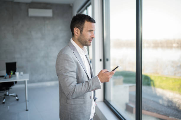 istock Businessman using phone in the office. 1471319135