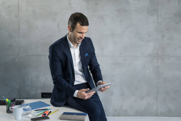 istock Happy businessman working on touchpad in the office. 1471319242